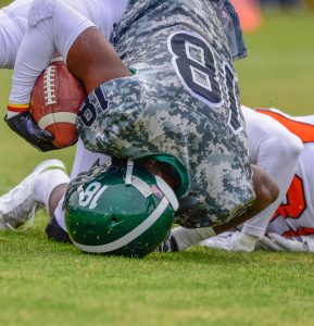 high school football player landing on head